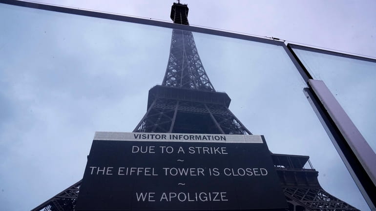 A board advertises a strike at the Eiffel Tower Monday,...