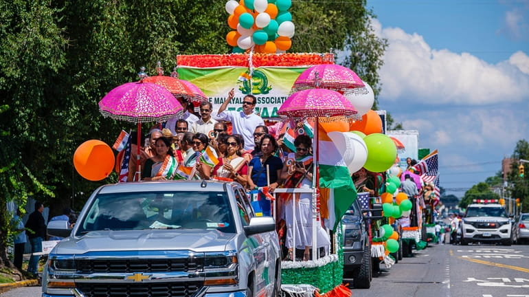 Members of the Indian community march and ride floats along...
