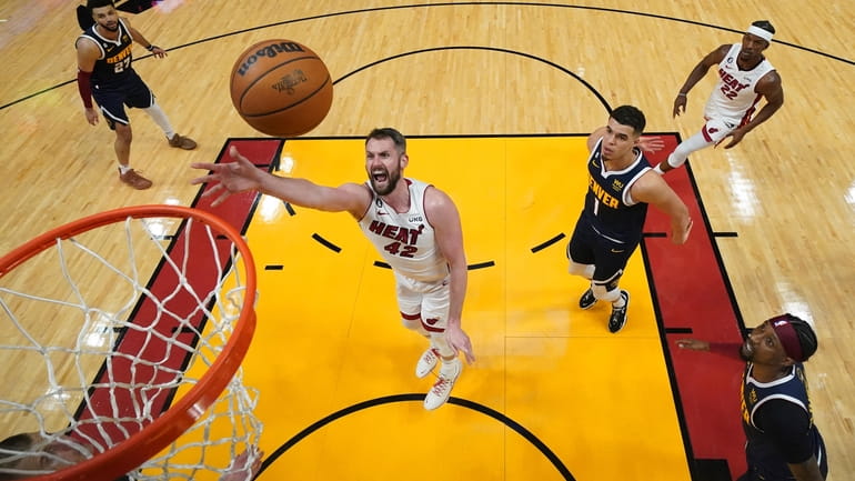 Miami Heat forward Kevin Love (42) shoots against the Denver...