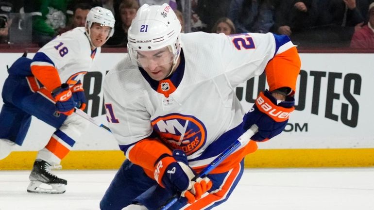 Islanders center Kyle Palmieri skates with the puck against Coyotes...