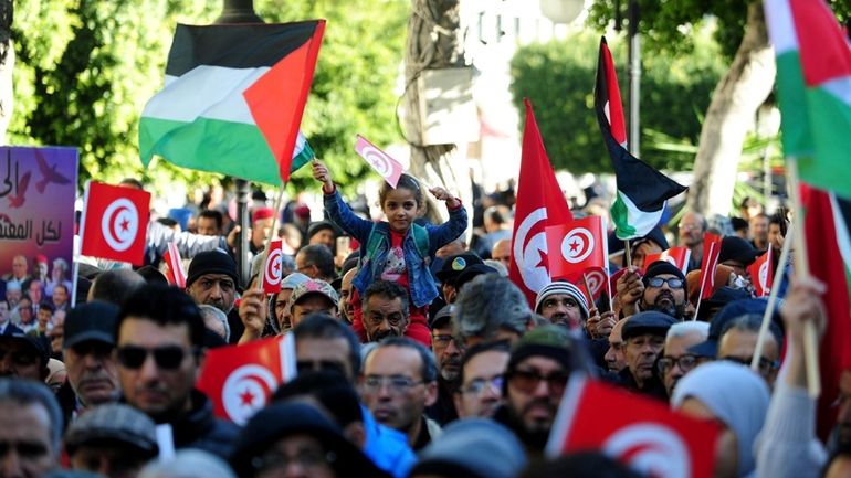 People commemorate the 13th anniversary of the Tunisian uprising in...