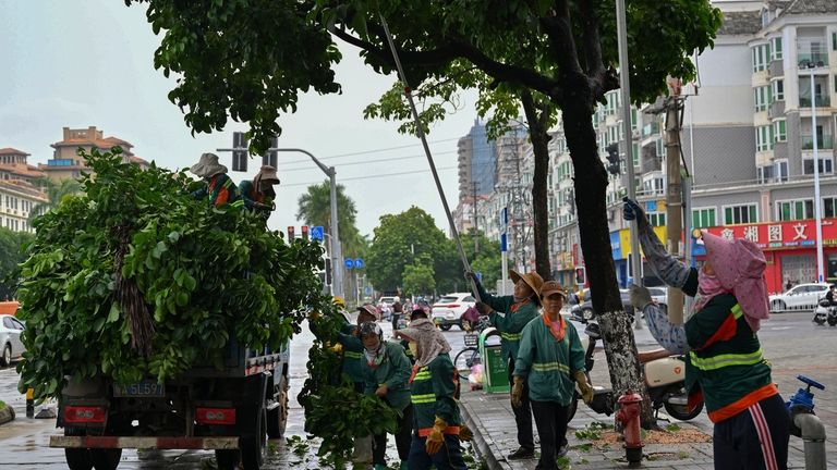 In this image released by Xinhua News Agency, workers cut...