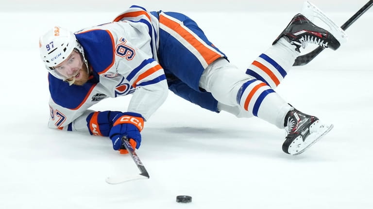Edmonton Oilers forward Connor McDavid is tripped during second-period Game...