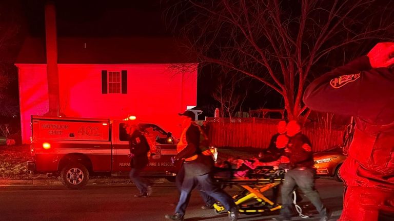 First responders carry an injured person away after an explosion...