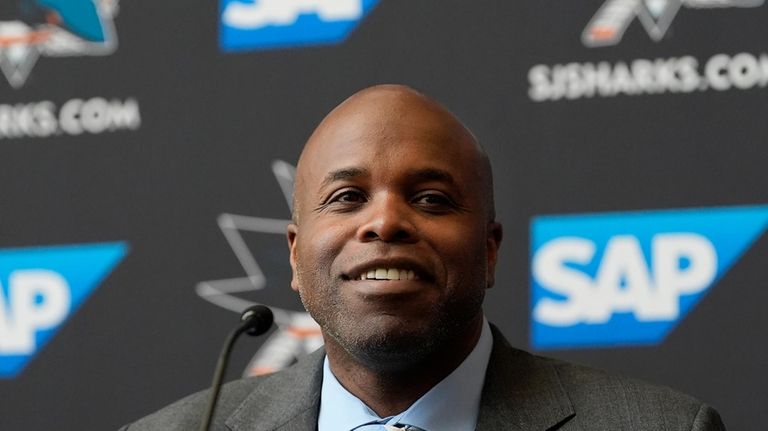 San Jose Sharks general manager Mike Grier speaks at a...