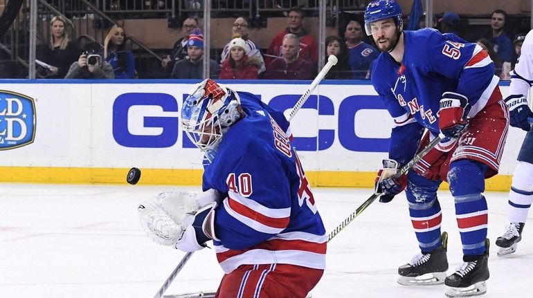 Rangers goaltender Alexandar Georgiev makes a save as defenseman Adam...