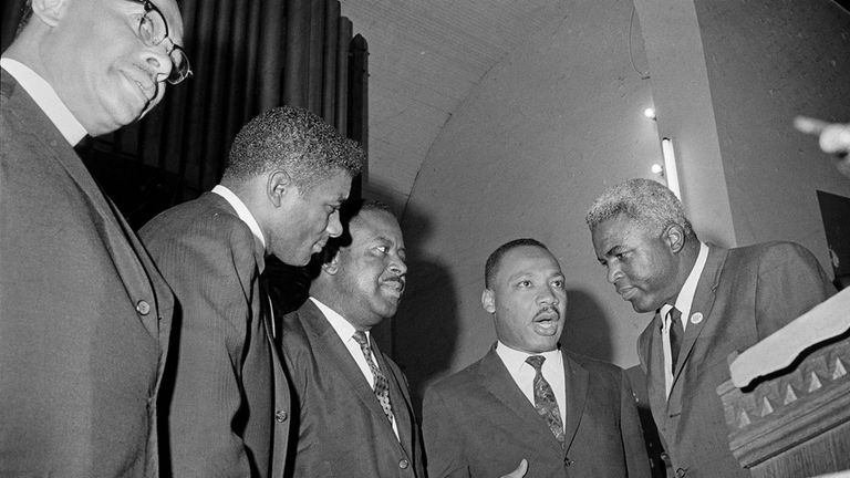 Boxer Floyd Patterson, left, and former baseball player Jackie Robinson,...