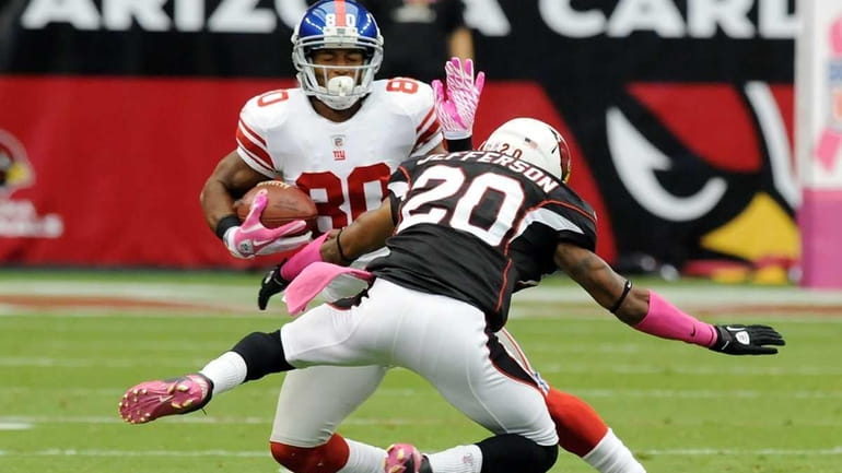 Victor Cruz makes a move on A.J. Jefferson of the...