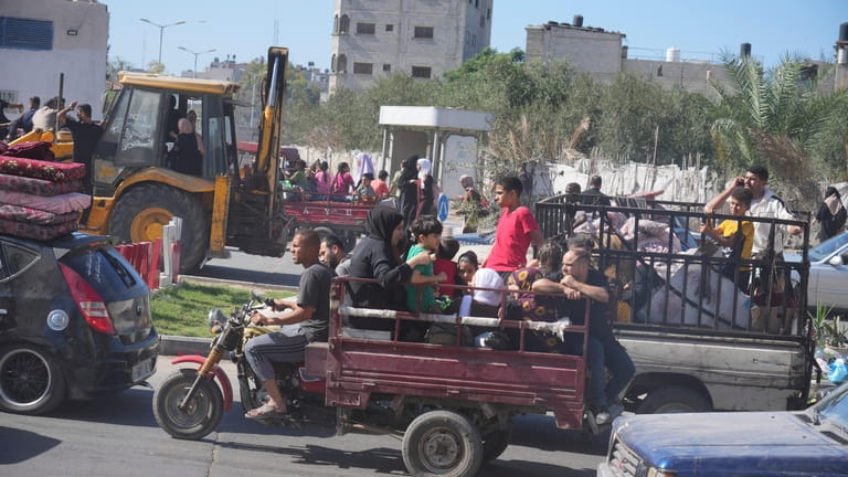 Palestinians flee to the southern Gaza Strip after the Israeli...