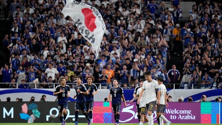 Japan's Kaoru Mitoma, left, celebrates his teams second goal during...