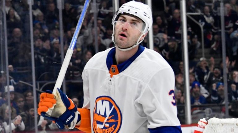 The Islanders' Adam Pelech looks away after a Jets goal...