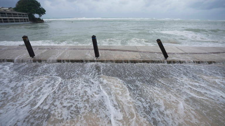 The sea floods the street after Hurricane Beryl passed through...