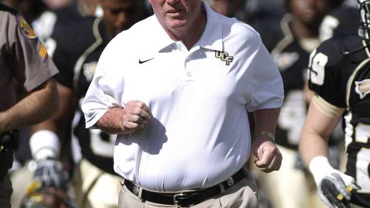 Central Florida head coach George O'Leary leads his players onto...