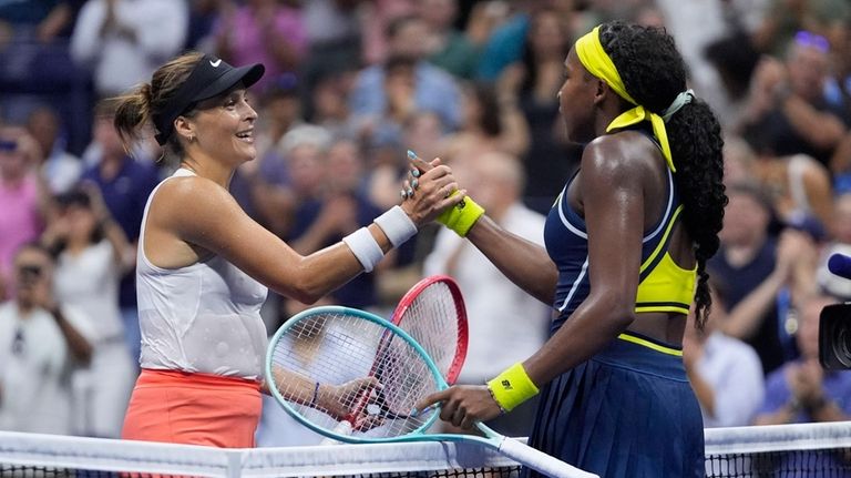 Coco Gauff, right, of the United States, shakes hands with...