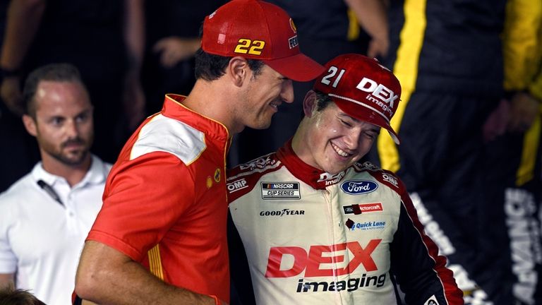 Harrison Burton (21) is congratulated by Joey Logano (22) after...