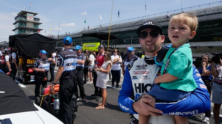 Chase Briscoe holds his son, Brooks, during qualifications for the...