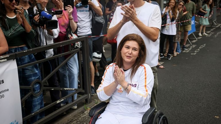 Press agency photographer Christina Assi arrives for the Olympic torch...