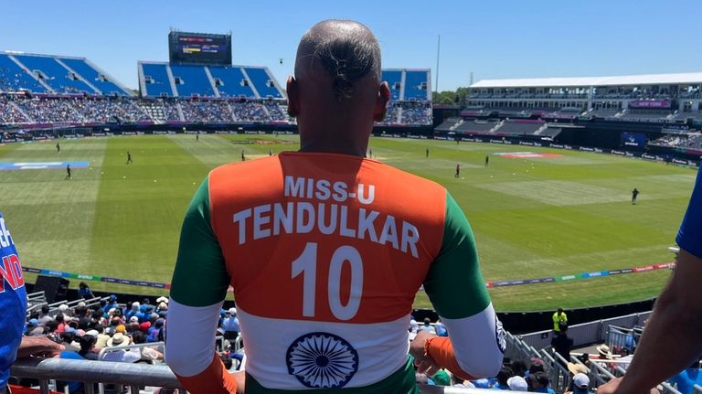 A fan of team India watches as India takes on Bangladesh...