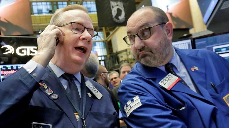 Trader Dennis Maguire, with specialist Peter Giacchi, right, on the...