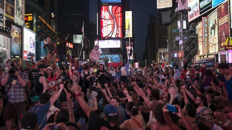 Demonstrators attend a protest march in Times Square in response...