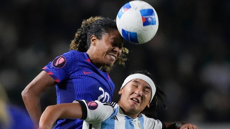 U.S. defender Casey Krueger, left, and Argentina forward Estefania Palomar...