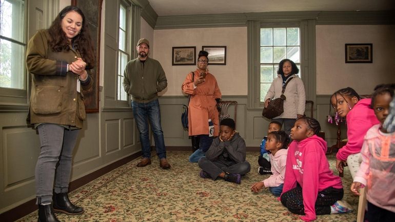 Lauren Brincat, the curator for Preservation Long Island, conducts a...