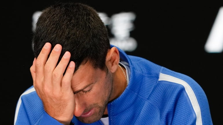 Novak Djokovic of Serbia reacts during a press conference following...