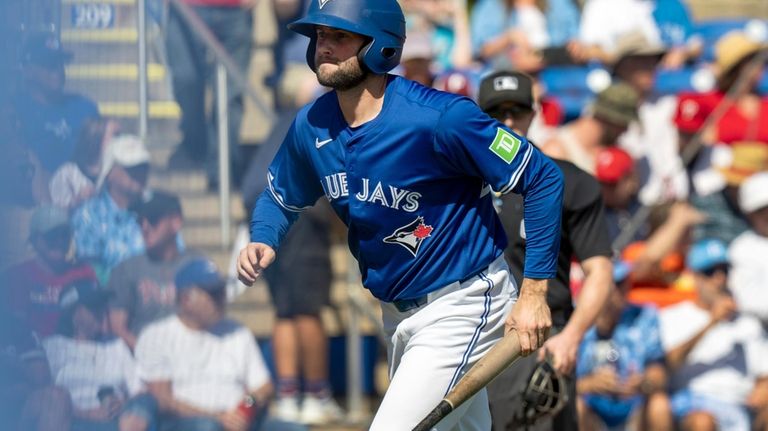 Toronto Blue Jays pitcher Tim Mayza plays bat boy during...