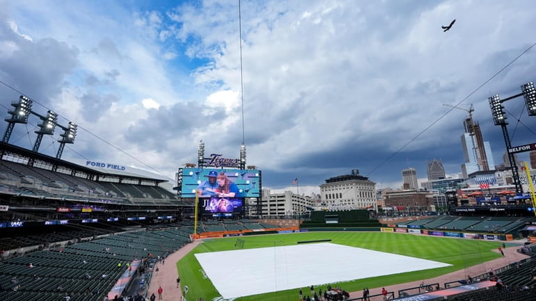 A tarp covers the infield at Comerica Park, where the...