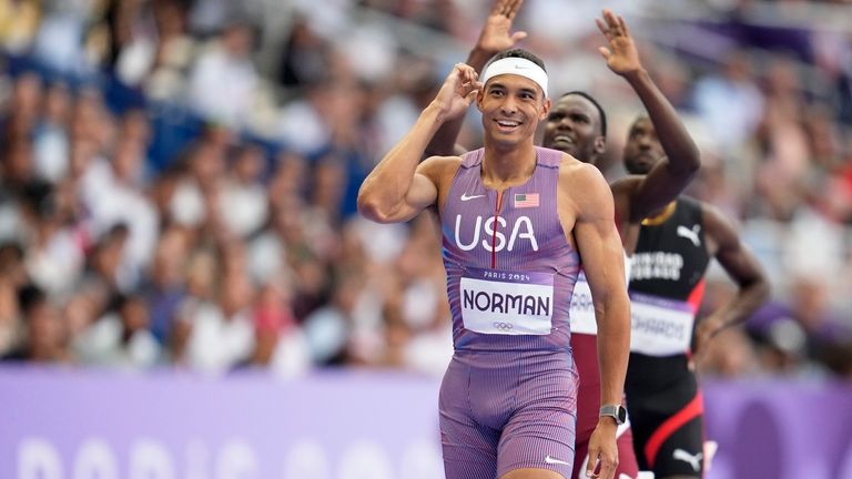 Michael Norman, of the United States, smiles after winning a...