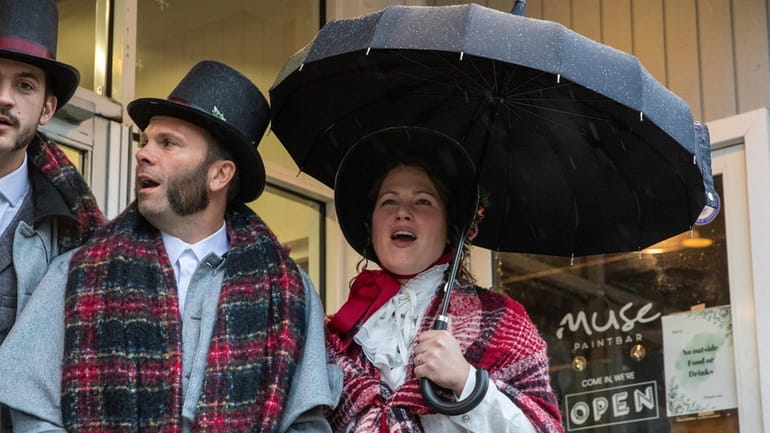 Eric Grasso and Chelsea Penna of the Conneciticut Carolers sing at the Dickens...