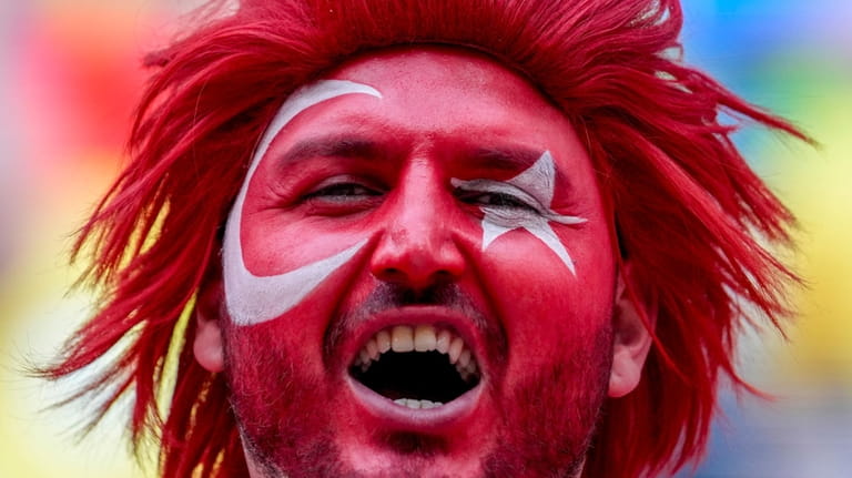 A Turkish fan celebrates prior to a round of sixteen...