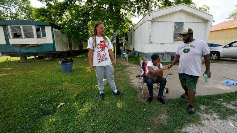 Mildred Joyner, seated, and her brother Antonio Joyner, left, who...