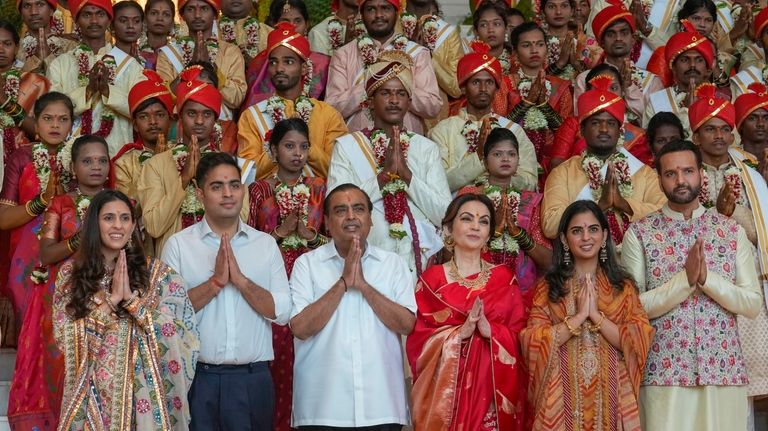 Chairman of Reliance Industries Limited Mukesh Ambani, third left, poses...