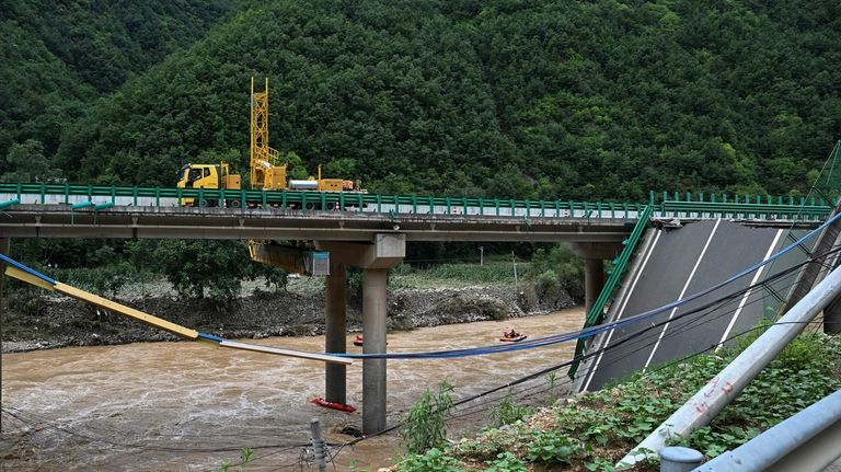 In this photo released by Xinhua News Agency, rescuers conduct...