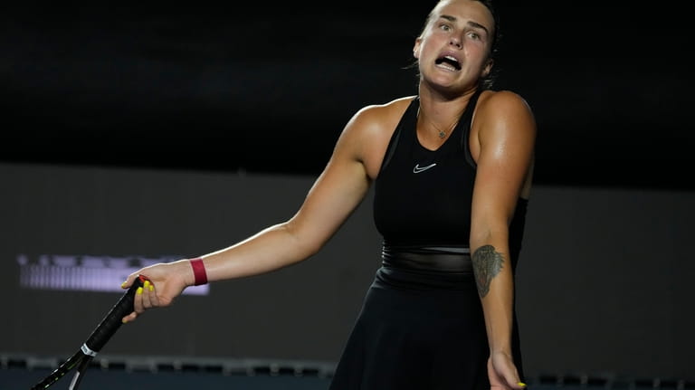 Aryna Sabalenka, of Belarus, reacts after losing a point to...
