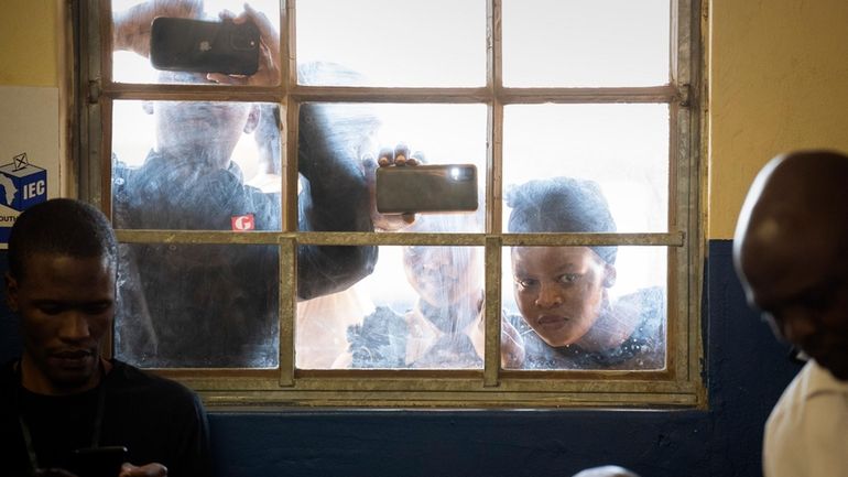 People watch as former president of the A.N.C. and South...