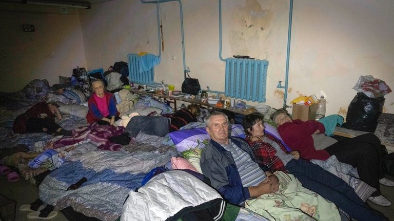 Local residents hide in a basement in Sudzha, Kursk region,...