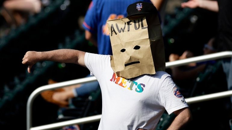 A Mets fan reacts during the ninth inning against Atlanta...