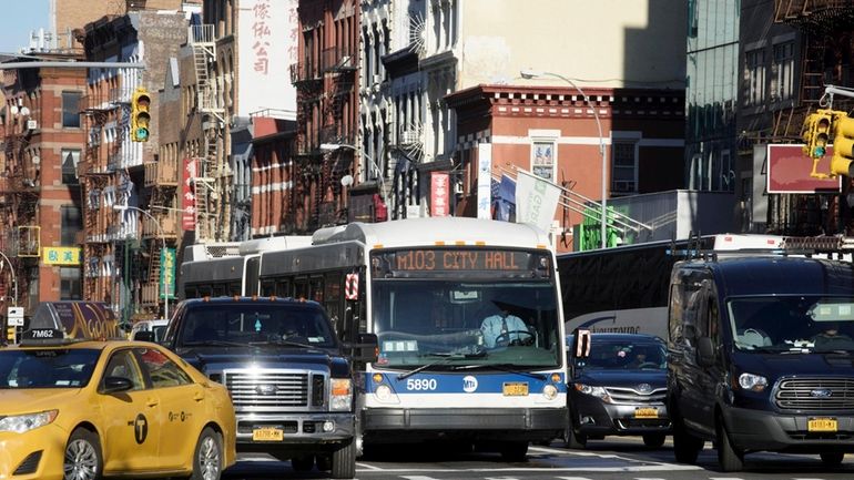 An M103 bus travels along the Bowery in Manhattan in...