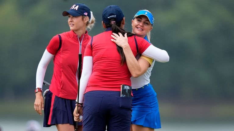 Europe's Charley Hull, right, congratulates United States' Allisen Corpuz, center,...