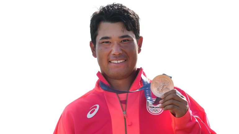 Hideki Matsuyama, of Japan, pose with his bronze medal following...