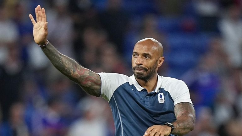 France's head coach Thierry Henry waves to fans as he...