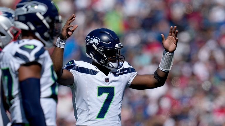 Seattle Seahawks quarterback Geno Smith (7) celebrates after running back...