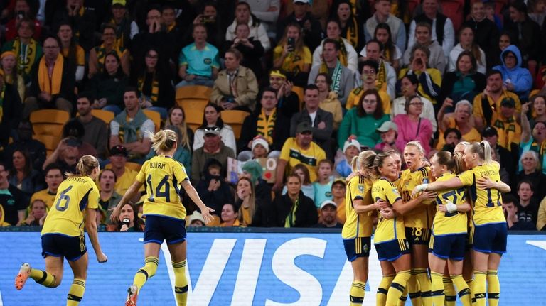 Sweden celebrate after scoring their first goal during the Women's...