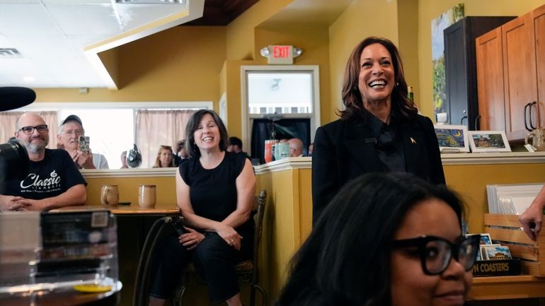 Democratic presidential nominee Vice President Kamala Harris, right, is greeted...