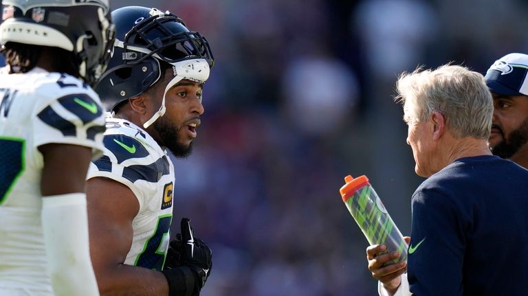 Seattle Seahawks linebacker Bobby Wagner talks with head coach Pete...