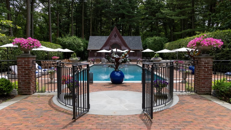 The property has an in-ground pool and pool house.