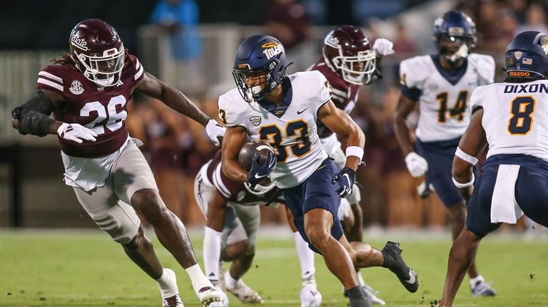 Toledo wide receiver Bryson Hammer (33) runs for a first...