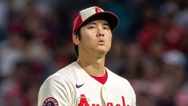 Los Angeles Angels starting pitcher Shohei Ohtani looks up after...